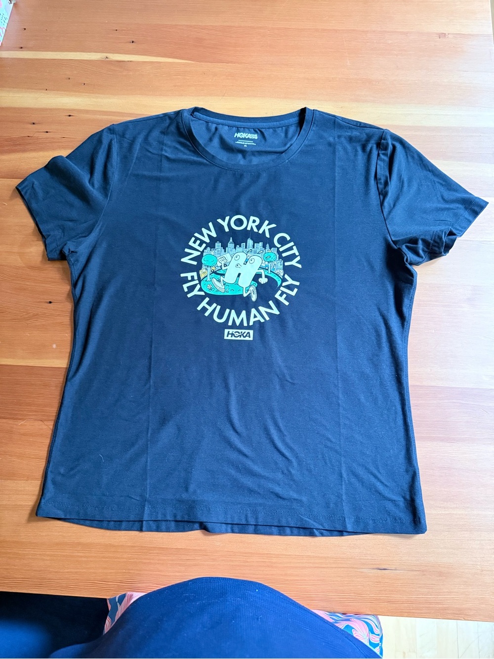Hoka One One Black Tee with Teal and White New York City Fly Human Fly Graphic
